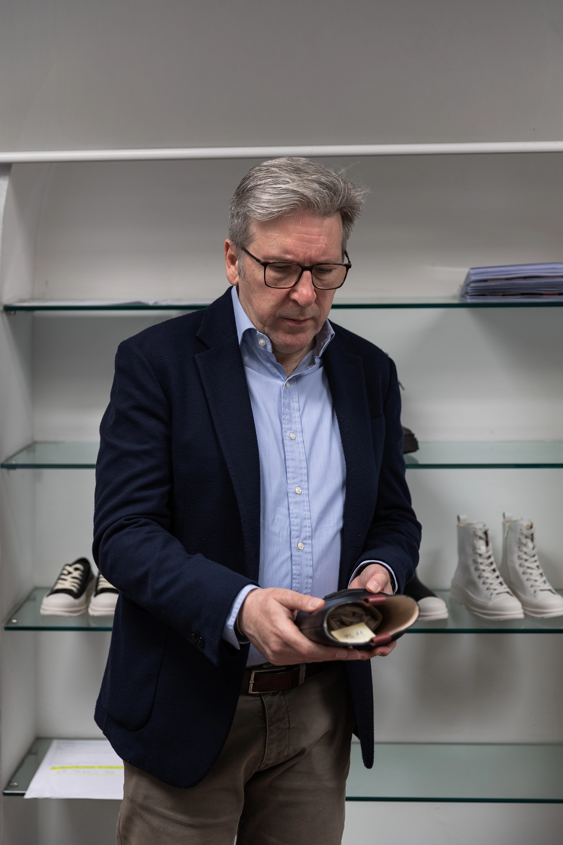 Domenico carefully inspecting an ankle boot